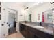 Bathroom with granite countertop, double vanity, and tile floors at 4932 Eastlake Vista Dr, St Cloud, FL 34771