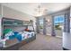 Bedroom features a bunk bed, carpet, two windows, ceiling fan, and neutral paint at 4932 Eastlake Vista Dr, St Cloud, FL 34771