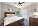 Bedroom with wood floors, ceiling fan, queen bed, and neutral paint at 4932 Eastlake Vista Dr, St Cloud, FL 34771