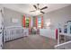 Bright bedroom with carpet, two windows with curtains, and Bedroom furniture at 4932 Eastlake Vista Dr, St Cloud, FL 34771