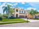 Stunning two-story home with a three-car garage, lush landscaping, and a welcoming entrance at 4932 Eastlake Vista Dr, St Cloud, FL 34771
