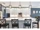 Stylish kitchen island with quartz countertops, white cabinets, and modern pendant lighting at 4932 Eastlake Vista Dr, St Cloud, FL 34771