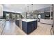 Open-concept kitchen with a large island, stainless steel appliances, and views of the living area at 4932 Eastlake Vista Dr, St Cloud, FL 34771
