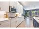 Modern kitchen featuring sleek countertops, stainless steel appliances, and a breakfast bar area at 4932 Eastlake Vista Dr, St Cloud, FL 34771