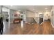 Open living area featuring a foosball table, wood floors, and staircase at 4932 Eastlake Vista Dr, St Cloud, FL 34771