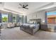 Serene main bedroom suite with a large bed, sitting area, and abundant natural light at 4932 Eastlake Vista Dr, St Cloud, FL 34771