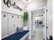 Welcoming mudroom features built-in bench, coat hooks, and convenient access to laundry room with modern washer and dryer at 4932 Eastlake Vista Dr, St Cloud, FL 34771