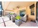 Covered patio with comfortable seating, ceiling fans, and a view of the screened-in pool area at 4932 Eastlake Vista Dr, St Cloud, FL 34771