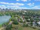 Scenic aerial view of a residential neighborhood near a tranquil lake, with the city skyline visible in the distance at 511 Woodlawn Blvd, Orlando, FL 32801