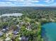 Beautiful aerial view of a lush residential neighborhood, featuring a lake and green spaces under a partly cloudy sky at 511 Woodlawn Blvd, Orlando, FL 32801