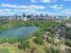 Panoramic aerial view of a city skyline, lake, and residential area surrounded by lush green trees and foliage at 511 Woodlawn Blvd, Orlando, FL 32801