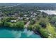 Stunning aerial view featuring a large lake surrounded by lush greenery, beautiful homes, and well-kept landscaping at 511 Woodlawn Blvd, Orlando, FL 32801