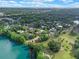Panoramic aerial view of a suburban neighborhood alongside a picturesque lake, filled with beautiful trees and foliage at 511 Woodlawn Blvd, Orlando, FL 32801