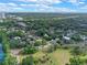Expansive aerial view of a residential neighborhood, showcasing tree-lined streets, and lush green spaces near a lake at 511 Woodlawn Blvd, Orlando, FL 32801