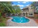 Inviting backyard boasts a large pool, lush landscaping, and a charming fountain for peaceful outdoor enjoyment at 511 Woodlawn Blvd, Orlando, FL 32801
