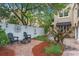 Charming outdoor living space with a fire pit, seating area, and lush landscaping provides a cozy spot for relaxation at 511 Woodlawn Blvd, Orlando, FL 32801