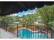 Balcony view showcasing the pool, the garden with fountain, and lush tropical landscaping for ultimate privacy at 511 Woodlawn Blvd, Orlando, FL 32801