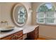 Bathroom vanity area with a bowl sink, decorative mirror, and natural light at 511 Woodlawn Blvd, Orlando, FL 32801