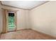 Bedroom with neutral carpet, baseboard trim, and a glass door leading to a balcony overlooking the backyard at 511 Woodlawn Blvd, Orlando, FL 32801