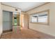 Bedroom with neutral carpet, large windows, baseboard trim, and a mirrored closet at 511 Woodlawn Blvd, Orlando, FL 32801