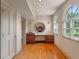 Bright dressing area with hardwood floors, built-in vanity, storage, and charming arched windows overlooking the grounds at 511 Woodlawn Blvd, Orlando, FL 32801