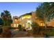 Charming stucco two-story home with manicured landscaping and awnings above the doors and windows at 511 Woodlawn Blvd, Orlando, FL 32801