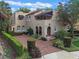 Charming two-story home featuring a beautiful brick driveway and well-maintained landscaping at 511 Woodlawn Blvd, Orlando, FL 32801