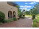 Stately home with a brick driveway and covered arched entryway, offering timeless elegance at 511 Woodlawn Blvd, Orlando, FL 32801