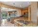 Gourmet kitchen featuring granite countertops, custom cabinets, and a gas cooktop at 511 Woodlawn Blvd, Orlando, FL 32801