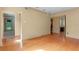 Spacious living room with hardwood floors and multiple entryways into other rooms of the house at 511 Woodlawn Blvd, Orlando, FL 32801