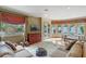 Open-concept living room featuring hardwood floors, natural light, and access to the pool at 511 Woodlawn Blvd, Orlando, FL 32801