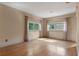 Well-lit living room featuring gleaming hardwood floors, neutral paint, and ample natural light from the large windows at 511 Woodlawn Blvd, Orlando, FL 32801