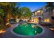 Backyard pool area with brick accents, landscaped greenery, and elegant exterior of the home at 511 Woodlawn Blvd, Orlando, FL 32801