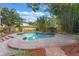 Private backyard featuring a sparkling pool, brick-paved patio, and lush tropical landscaping creates a serene outdoor space at 511 Woodlawn Blvd, Orlando, FL 32801