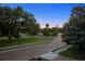 Scenic street view featuring lush landscaping, mature trees, and sidewalks in a serene neighborhood at 511 Woodlawn Blvd, Orlando, FL 32801