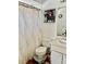 Cozy bathroom featuring a patterned shower curtain, shelving unit, and laminate countertops at 526 Seasons Ct, Winter Springs, FL 32708