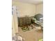 Cute carpeted Bedroom with a small crib, changing table, and colorful play rug at 526 Seasons Ct, Winter Springs, FL 32708