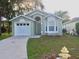 Charming single story home featuring a front-facing garage and well-maintained lawn at 526 Seasons Ct, Winter Springs, FL 32708