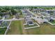 Aerial view of a home with solar panels and a fenced yard in a residential neighborhood at 5707 Fischer Dr, Lakeland, FL 33812