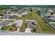 Aerial view of a home with solar panels, landscaping and a driveway in a suburban neighborhood at 5707 Fischer Dr, Lakeland, FL 33812