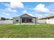 Spacious backyard with a pergola, green lawn, and a white privacy fence at 5707 Fischer Dr, Lakeland, FL 33812