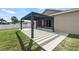 Backyard featuring a pergola over concrete patio with green grass and a white fence at 5707 Fischer Dr, Lakeland, FL 33812