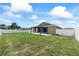 Expansive backyard showcasing a pergola and well-maintained lawn with a white fence at 5707 Fischer Dr, Lakeland, FL 33812