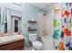 Colorful bathroom features a shower and tub combination with decorative dinosaur shower curtain at 5707 Fischer Dr, Lakeland, FL 33812