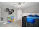 Bedroom with ceiling fan, door to hallway and decorative shelving on wall at 5707 Fischer Dr, Lakeland, FL 33812