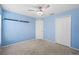 Bedroom with carpet, ceiling fan, double closet and light blue walls at 5707 Fischer Dr, Lakeland, FL 33812