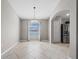 Dining area with neutral walls, tile flooring and modern chandelier lighting fixture at 5707 Fischer Dr, Lakeland, FL 33812