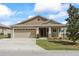 Inviting single-story home with a two-car garage and charming front porch, offering great curb appeal at 5707 Fischer Dr, Lakeland, FL 33812