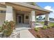 Welcoming front porch with stone-accented columns and landscaped flowerbeds, creating an inviting entrance at 5707 Fischer Dr, Lakeland, FL 33812