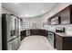 Spacious kitchen featuring stainless steel appliances, dark cabinetry, and granite countertops, a chef's dream at 5707 Fischer Dr, Lakeland, FL 33812